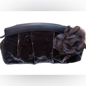 Loft velvet clutch with flower on side.